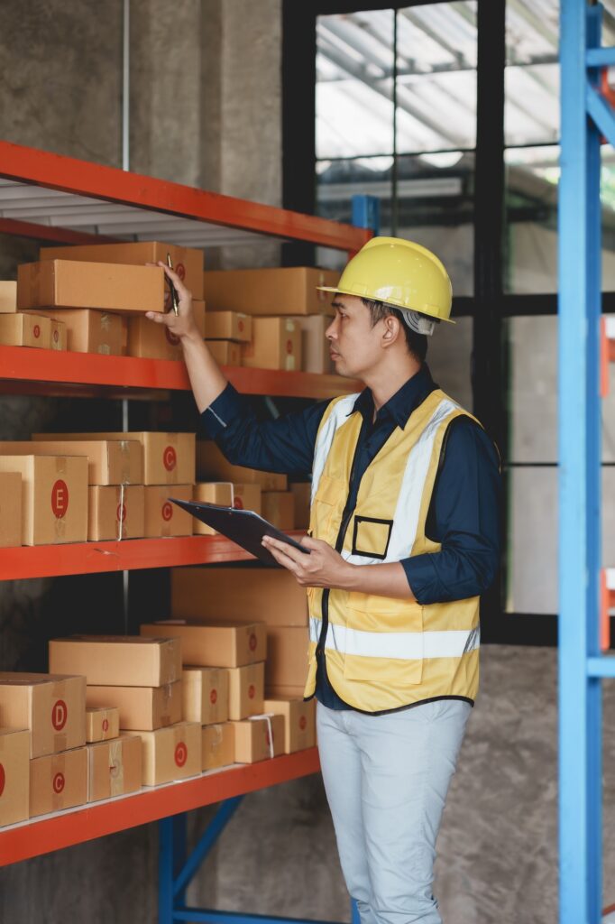 Asian male warehouse worker check and count inventory in the warehouse for accuracy and ease